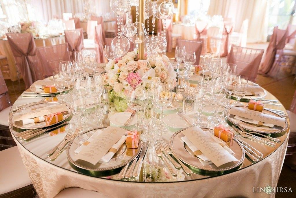 Champagne-toned wedding reception table set with flowers and place settings